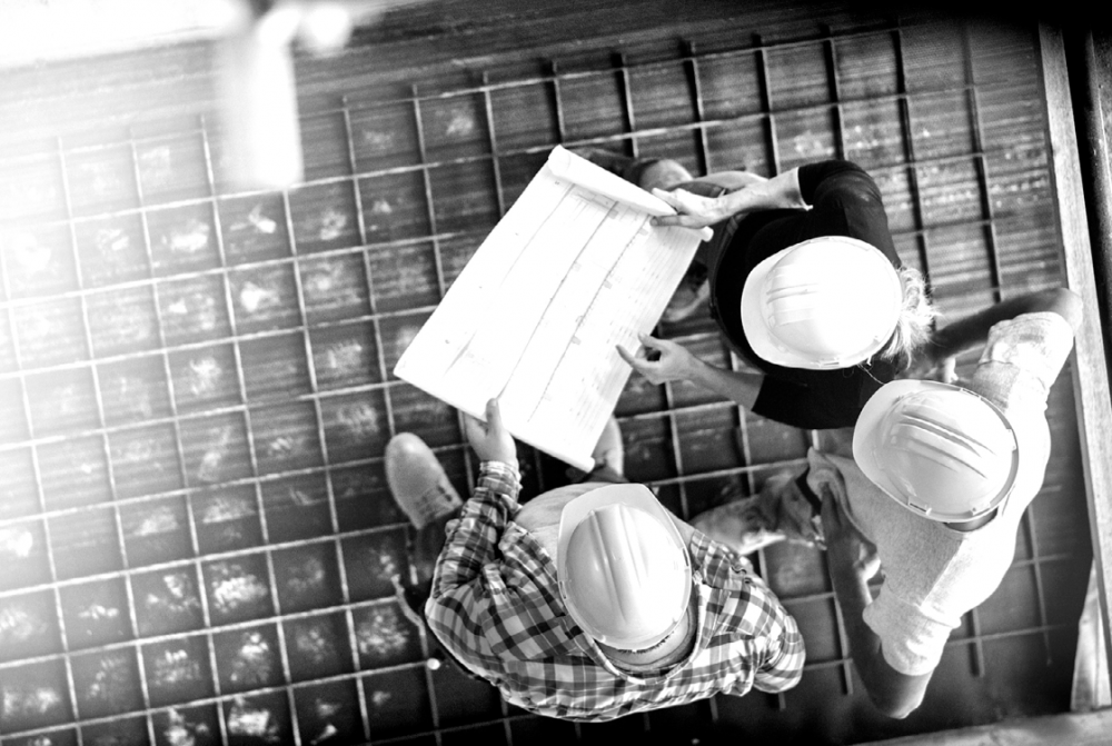 Contractors Liability - Building contractors on site in hard hats 